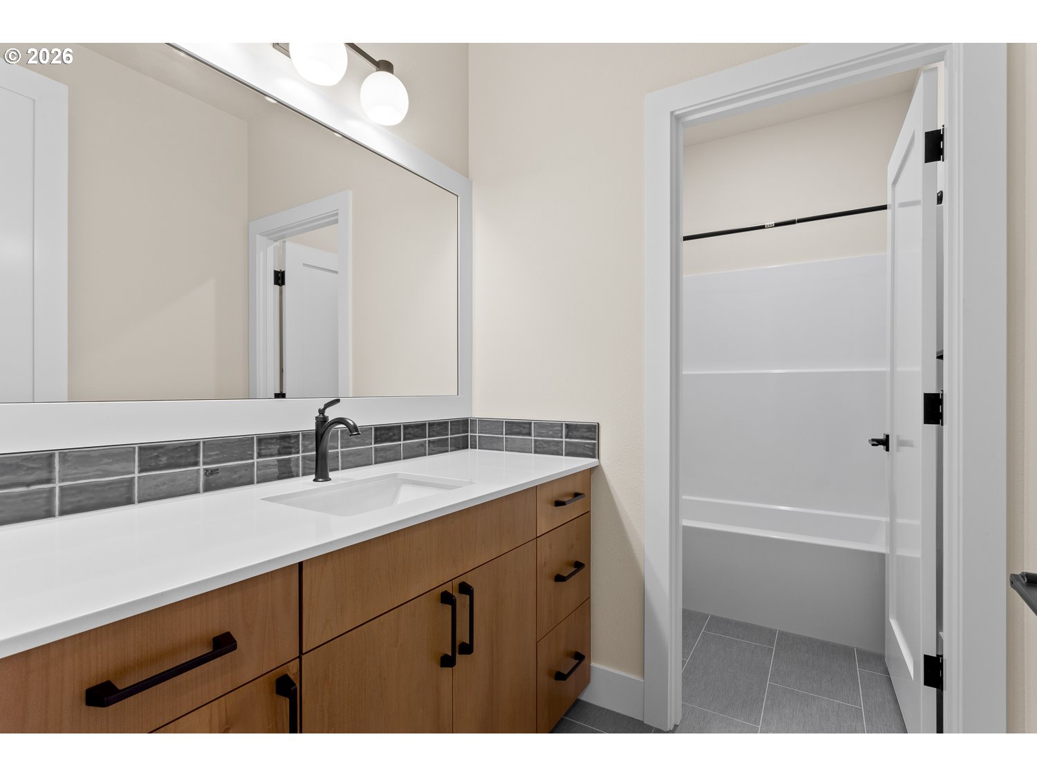 15666 Southwest Everglade Avenue Tigard, OR 97224 - Photo 36 of 45 a bathroom with a sink vanity granite tub and a mirror