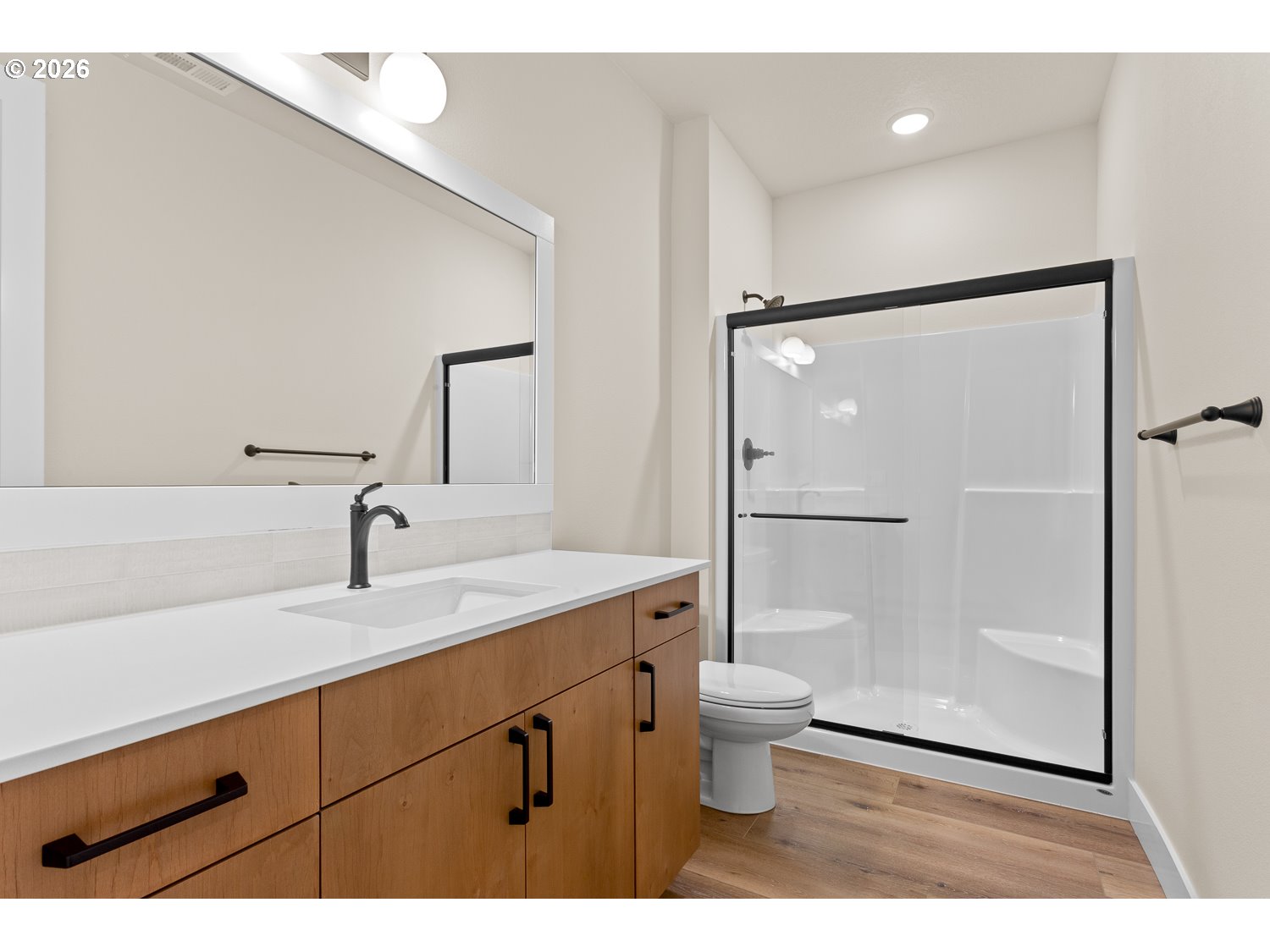 15666 Southwest Everglade Avenue Tigard, OR 97224 - Photo 6 of 45 a bathroom with a granite countertop sink toilet a mirror and shower