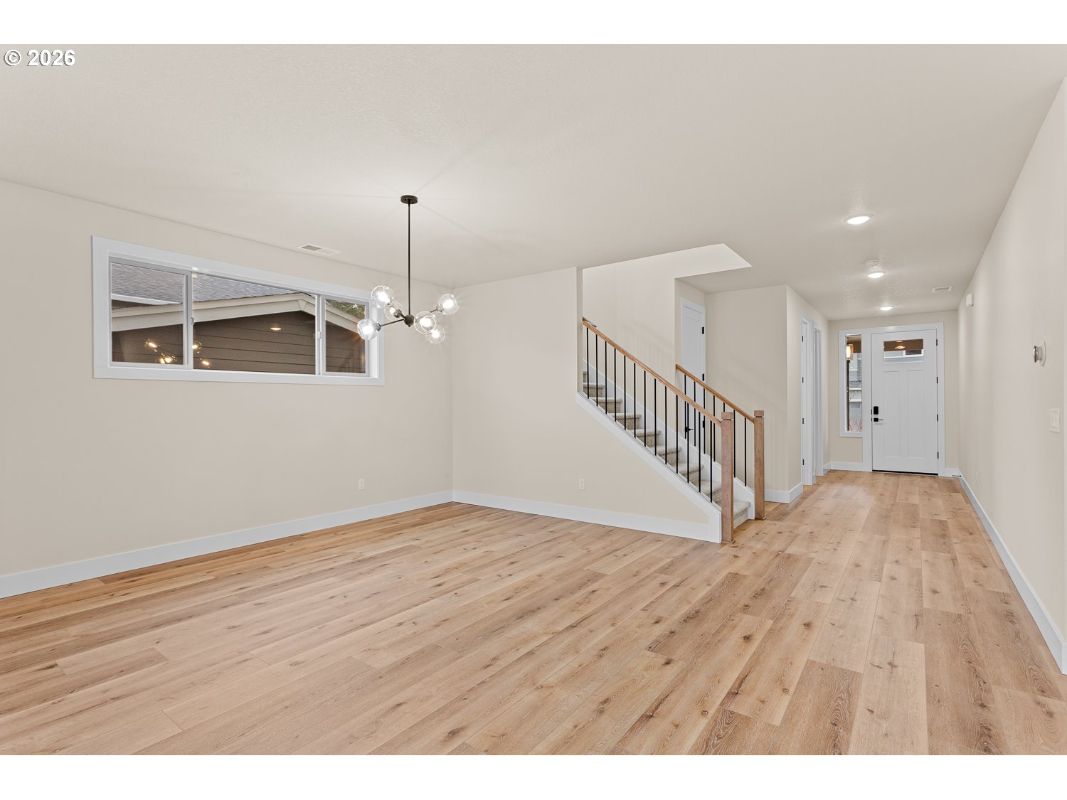 15666 Southwest Everglade Avenue Tigard, OR 97224 - Photo 9 of 45 a view of an empty room with wooden floor and windows