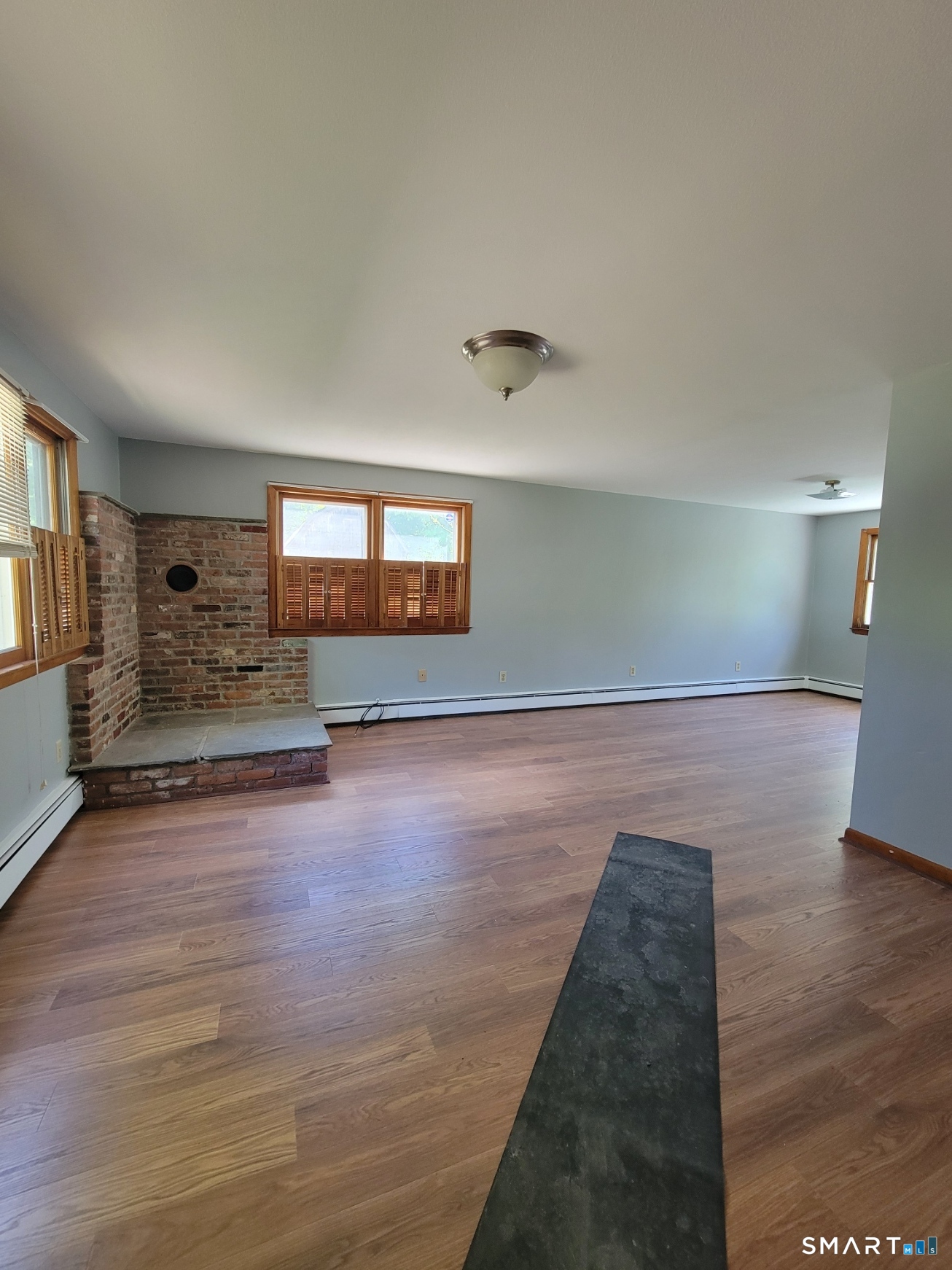 18 Parsonage Road Haddam, CT 06441 - Photo 2 of 10 a view of empty room with wooden floor and fireplace