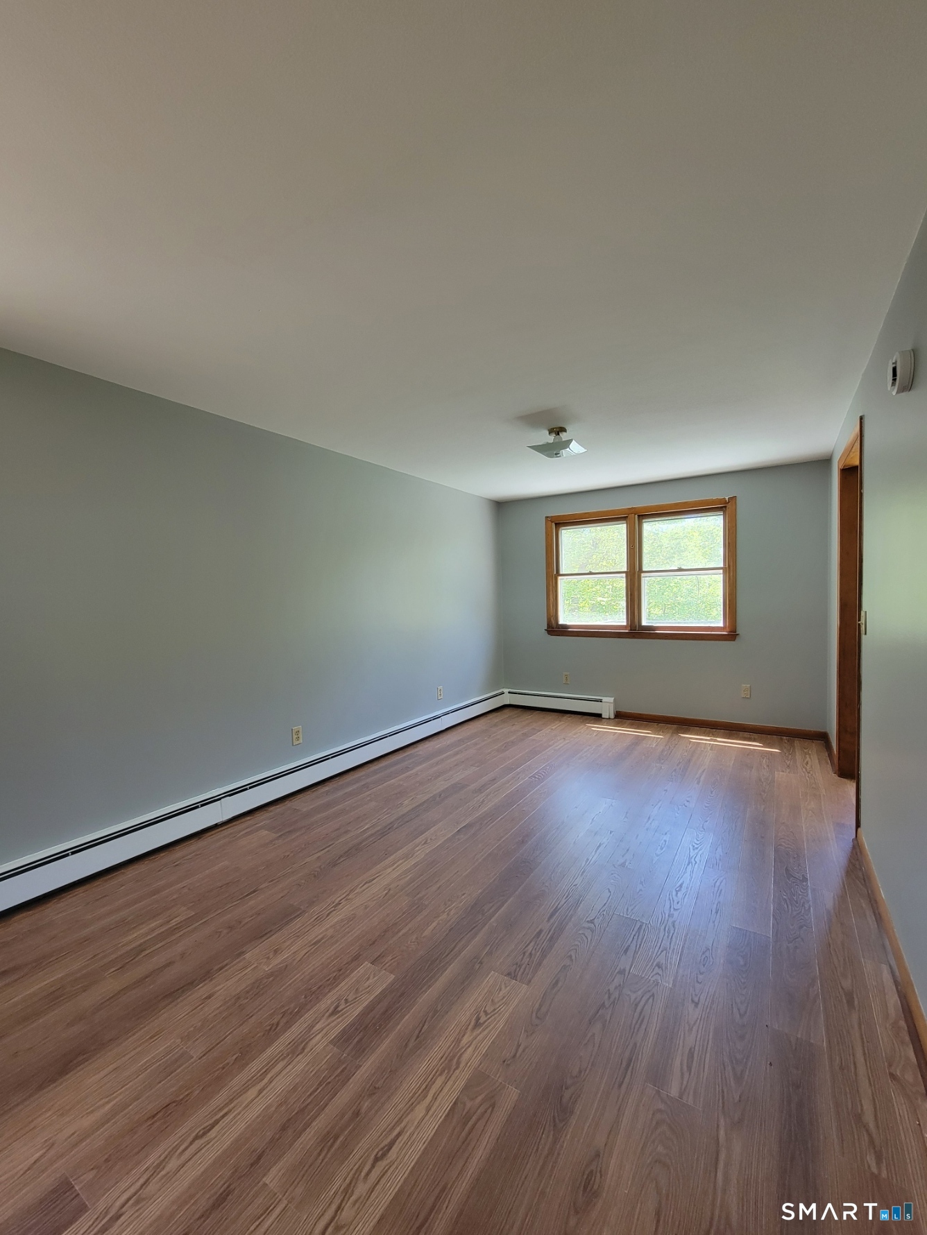 18 Parsonage Road Haddam, CT 06441 - Photo 3 of 10 a view of empty room with wooden floor and fan