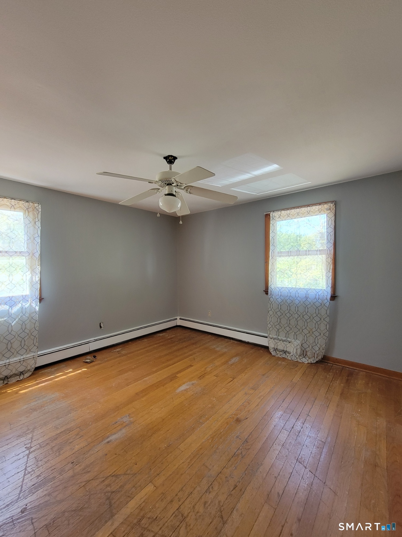 18 Parsonage Road Haddam, CT 06441 - Photo 7 of 10 an empty room with wooden floor and windows