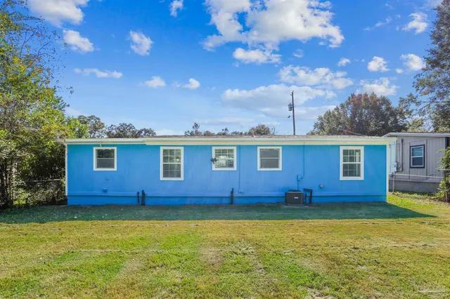 a view of a yard with an empty space and deck