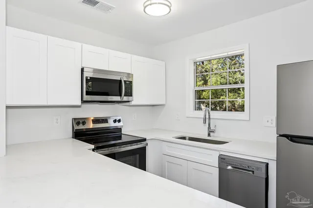 a kitchen with a microwave and a sink