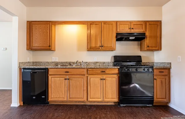 a kitchen with stainless steel appliances granite countertop a stove and a refrigerator