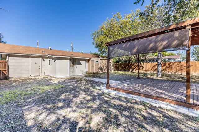 a view of a house with a yard and tree