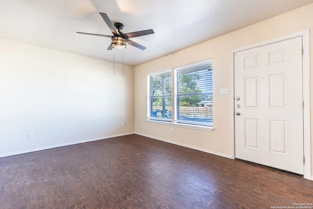 wooden floor in an empty room with a window