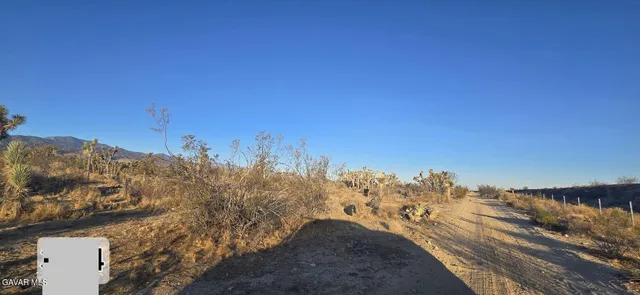 a view of a houses with mountains in the background