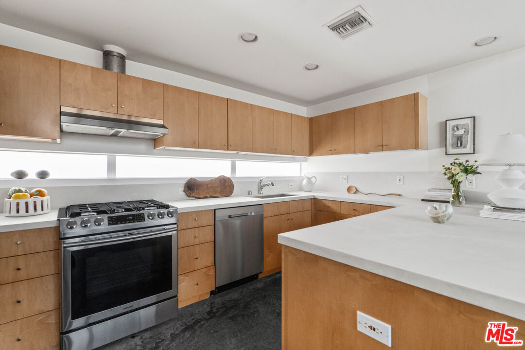 660 Rose Avenue, Unit 4 Venice, CA 90291 - Photo 9 of 25 a kitchen with a sink a stove and cabinets