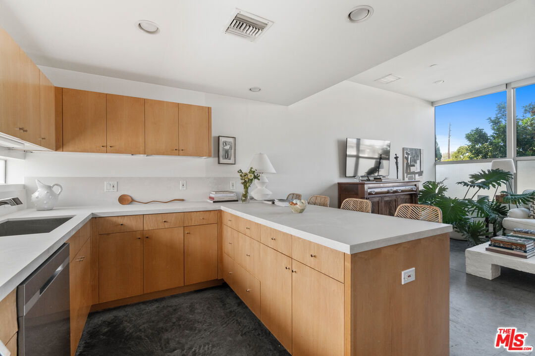 660 Rose Avenue, Unit 4 Venice, CA 90291 - Photo 10 of 25 a kitchen with a sink dishwasher and white cabinets with wooden floor