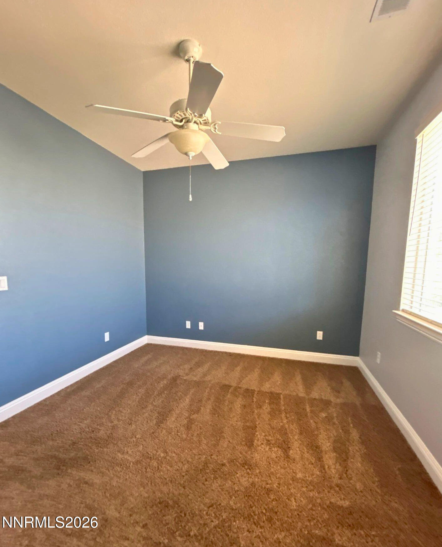 635 Ubaldo Court Reno, NV 89521 - Photo 17 of 22 an empty room with a window and a fan