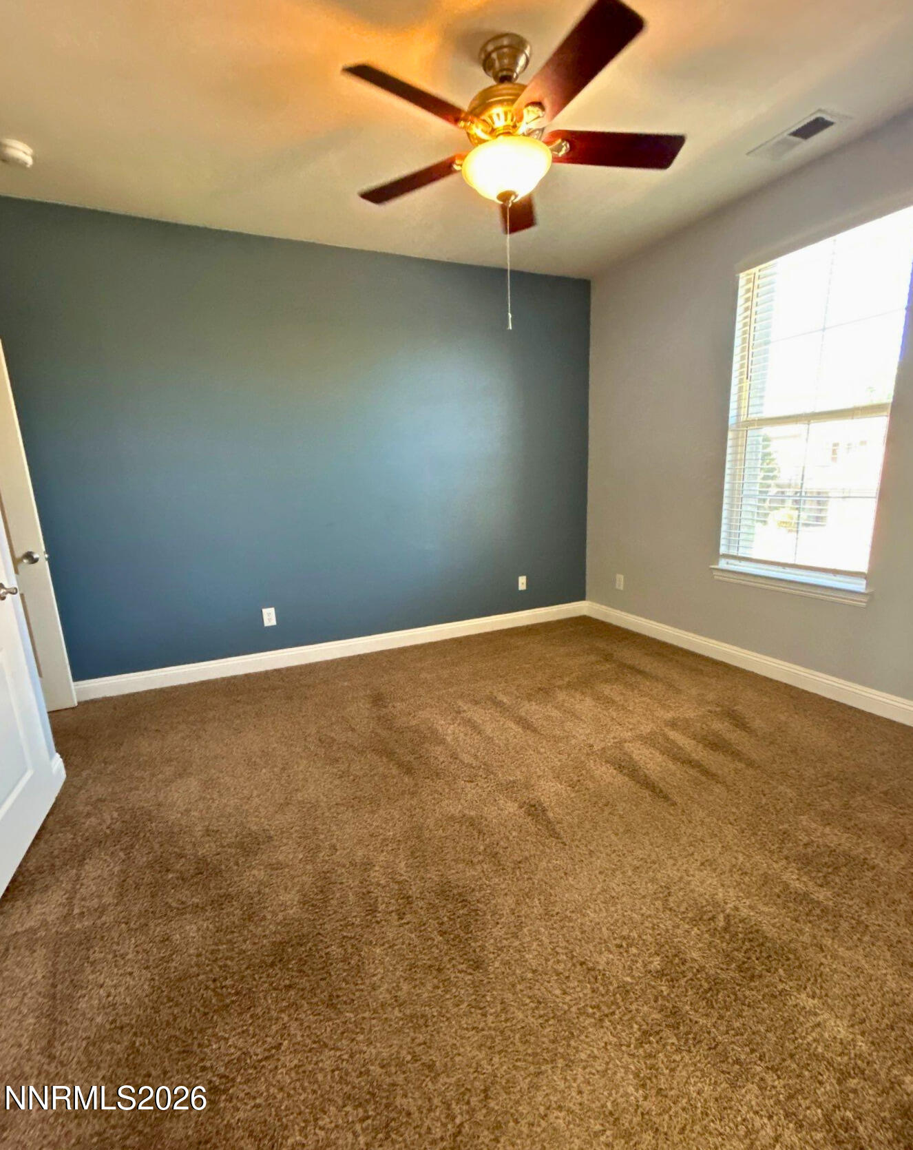 635 Ubaldo Court Reno, NV 89521 - Photo 20 of 22 an empty room with a window and a fan