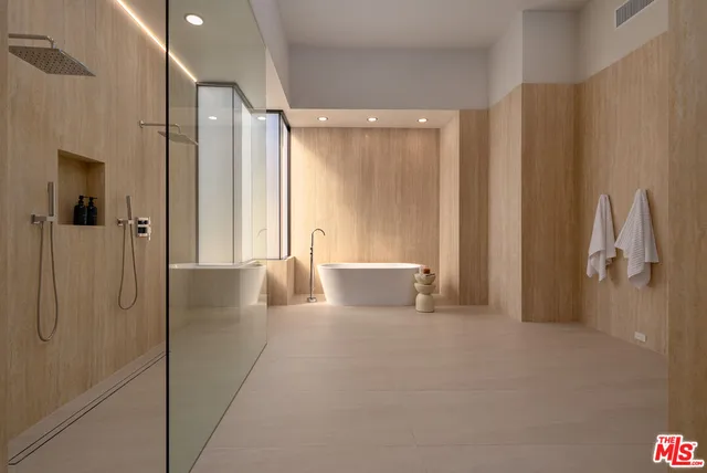 a bathroom with a shower and a glass door