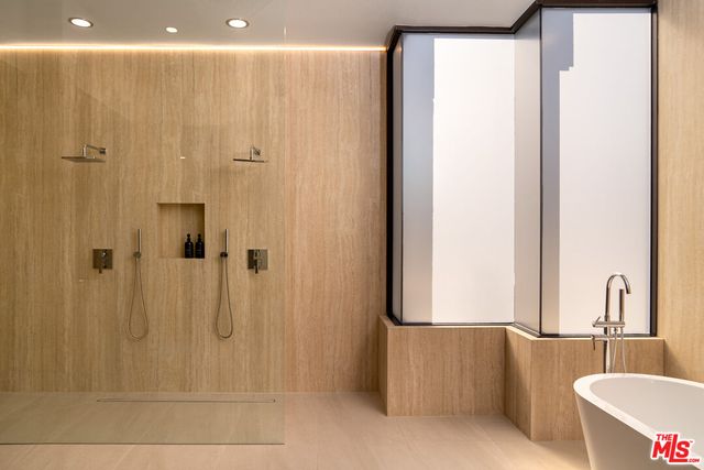 a bathroom with a bathtub and shower