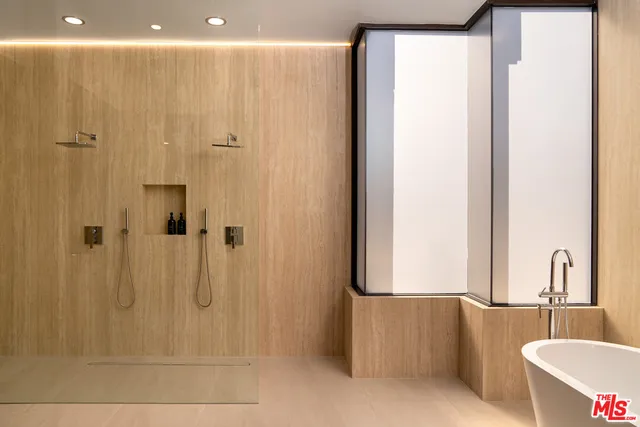 a bathroom with a bathtub and shower