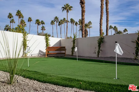 a living room with furniture and large windows