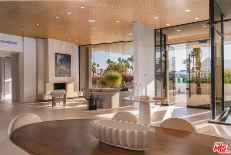 a living room with kitchen island furniture and a flat screen tv