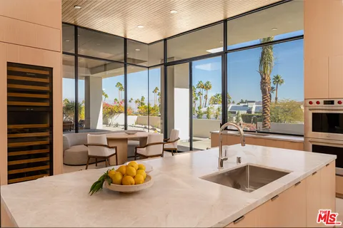 a kitchen with a large window and cabinets