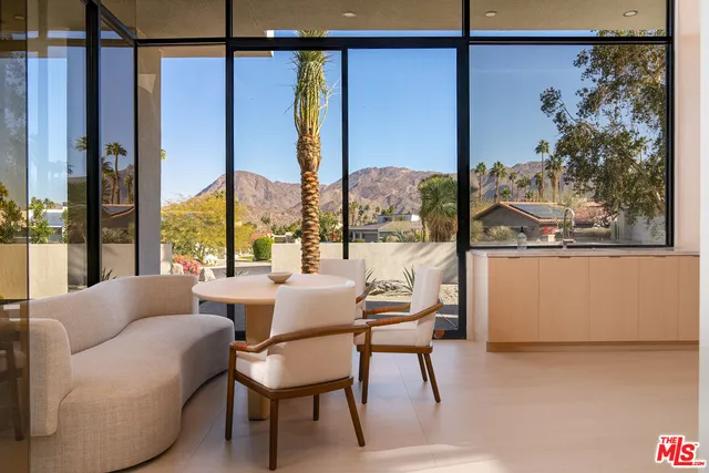 a balcony with furniture and a potted plant
