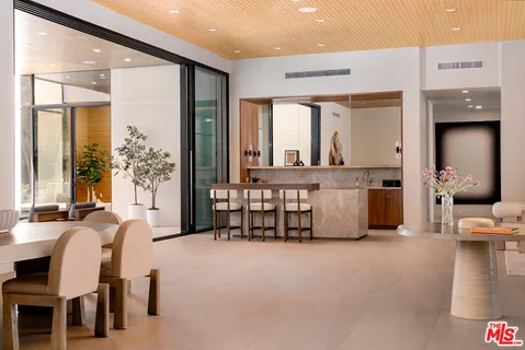 a living room with furniture and large windows