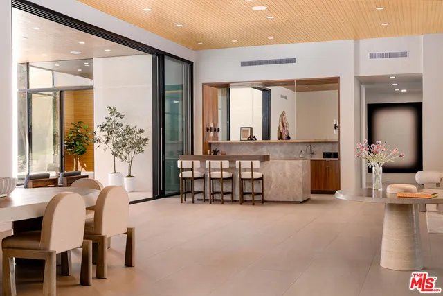 a living room with furniture and large windows