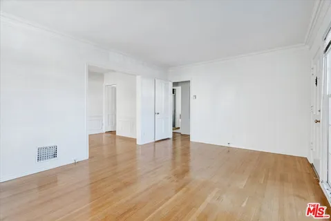 a view of an empty room and wooden floor