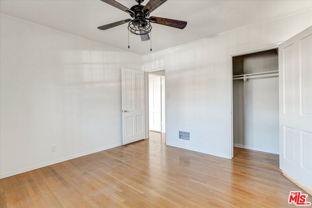 142 North Hamilton Drive, Unit A Beverly Hills, CA 90211 - Photo 5 of 8 a view of an empty room with a window and wooden floor