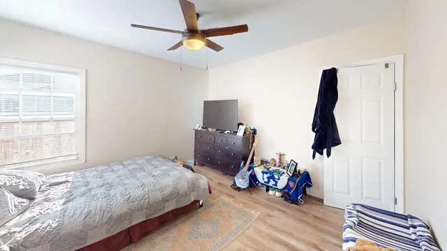 a bedroom with bed and window