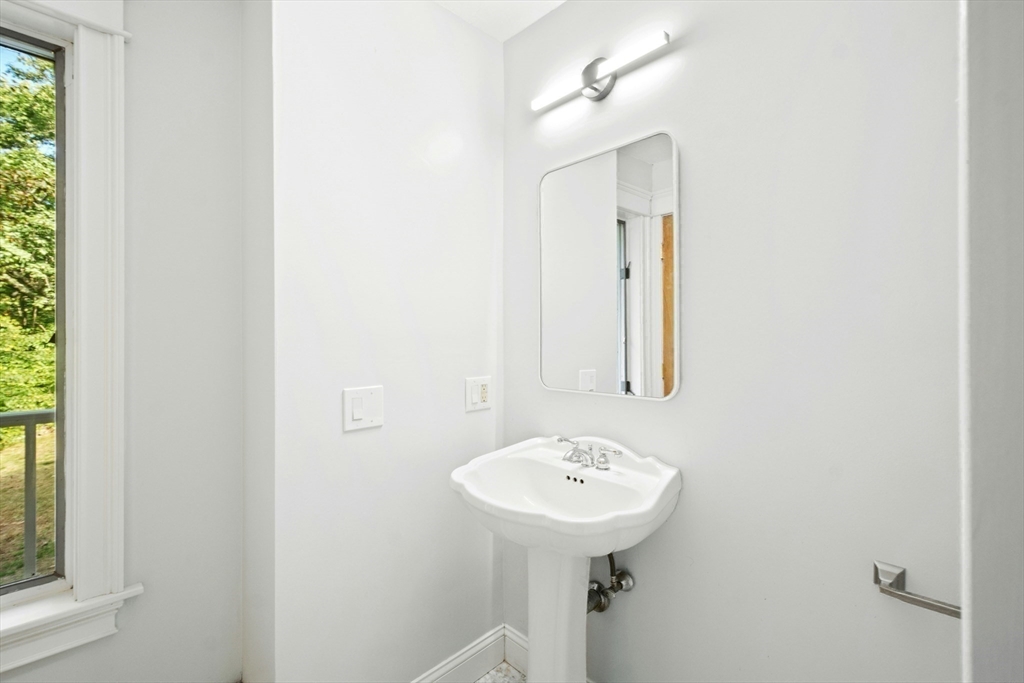 184 Old Bolton Road Stow, MA 01775 - Photo 18 of 39 a bathroom with a sink a mirror and a toilet