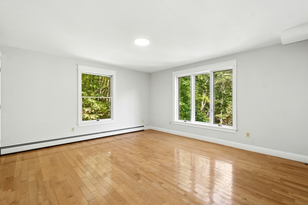 184 Old Bolton Road Stow, MA 01775 - Photo 28 of 39 an empty room with wooden floor and windows
