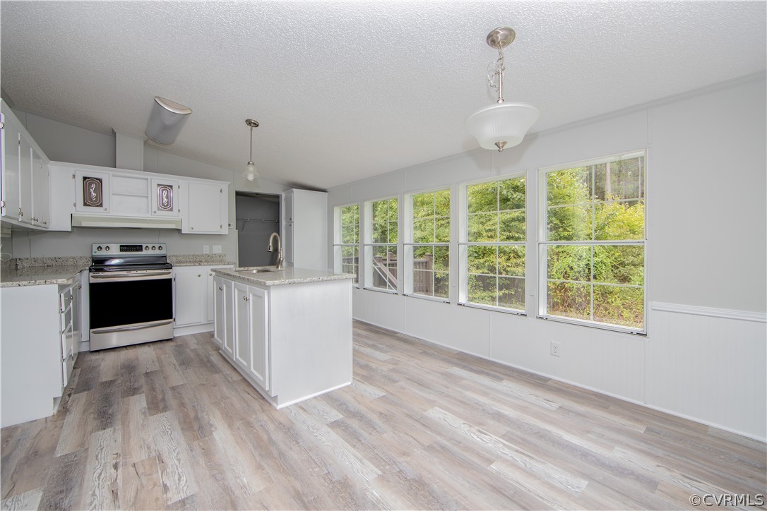 473 Goodwin Store Road Louisa, VA 23093 - Photo 5 of 28 a large kitchen with stainless steel appliances granite countertop a stove and a sink with cabinets