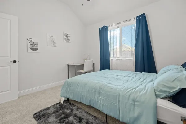 a bedroom with a bed and a chair in it