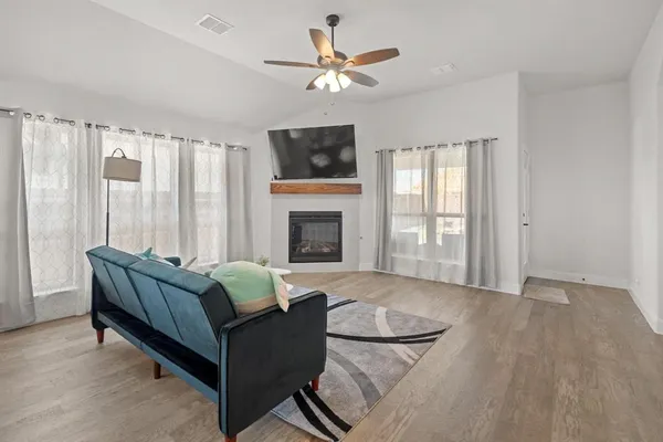 a living room with furniture and kitchen view