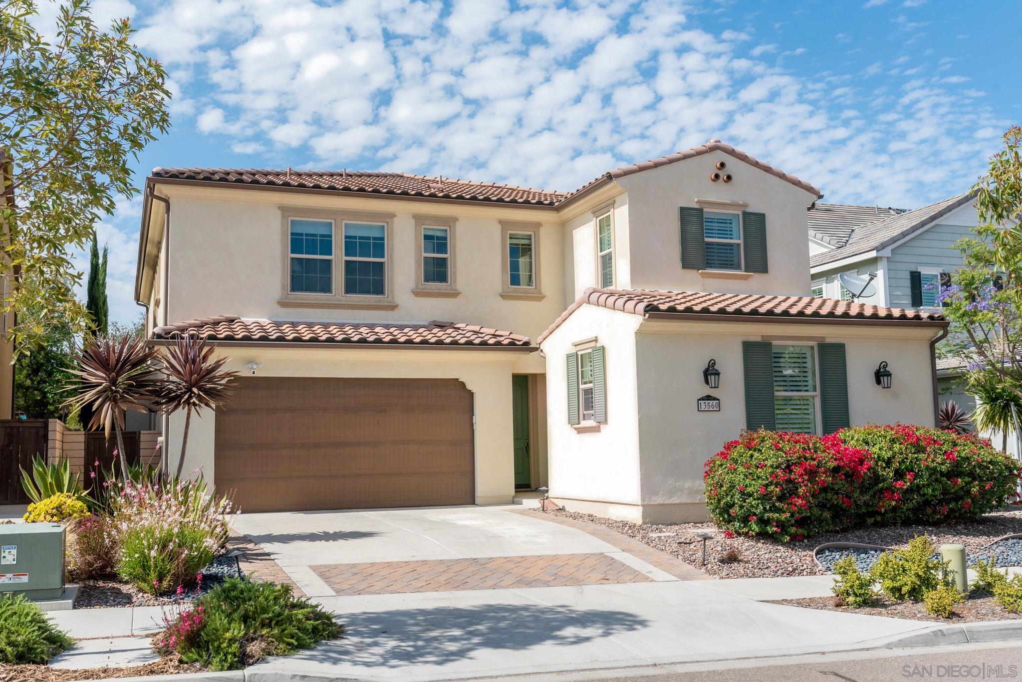 13560 Tierra Vista Circle San Diego, CA 92130 - Photo 1 of 52 a front view of a house with a yard and garage