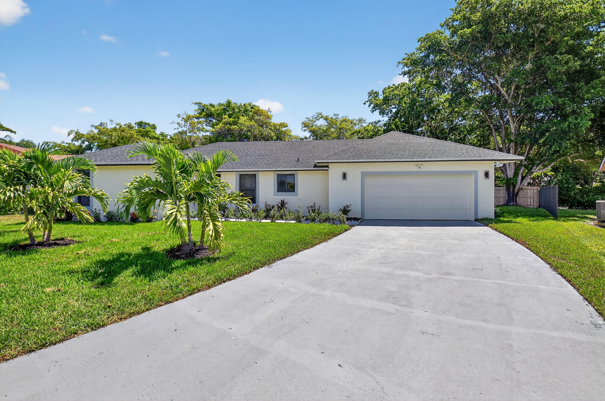 6251 Hitchin Post Way Delray Beach, FL 33484 - Photo 12 of 67 a front view of a house with a yard and potted plants