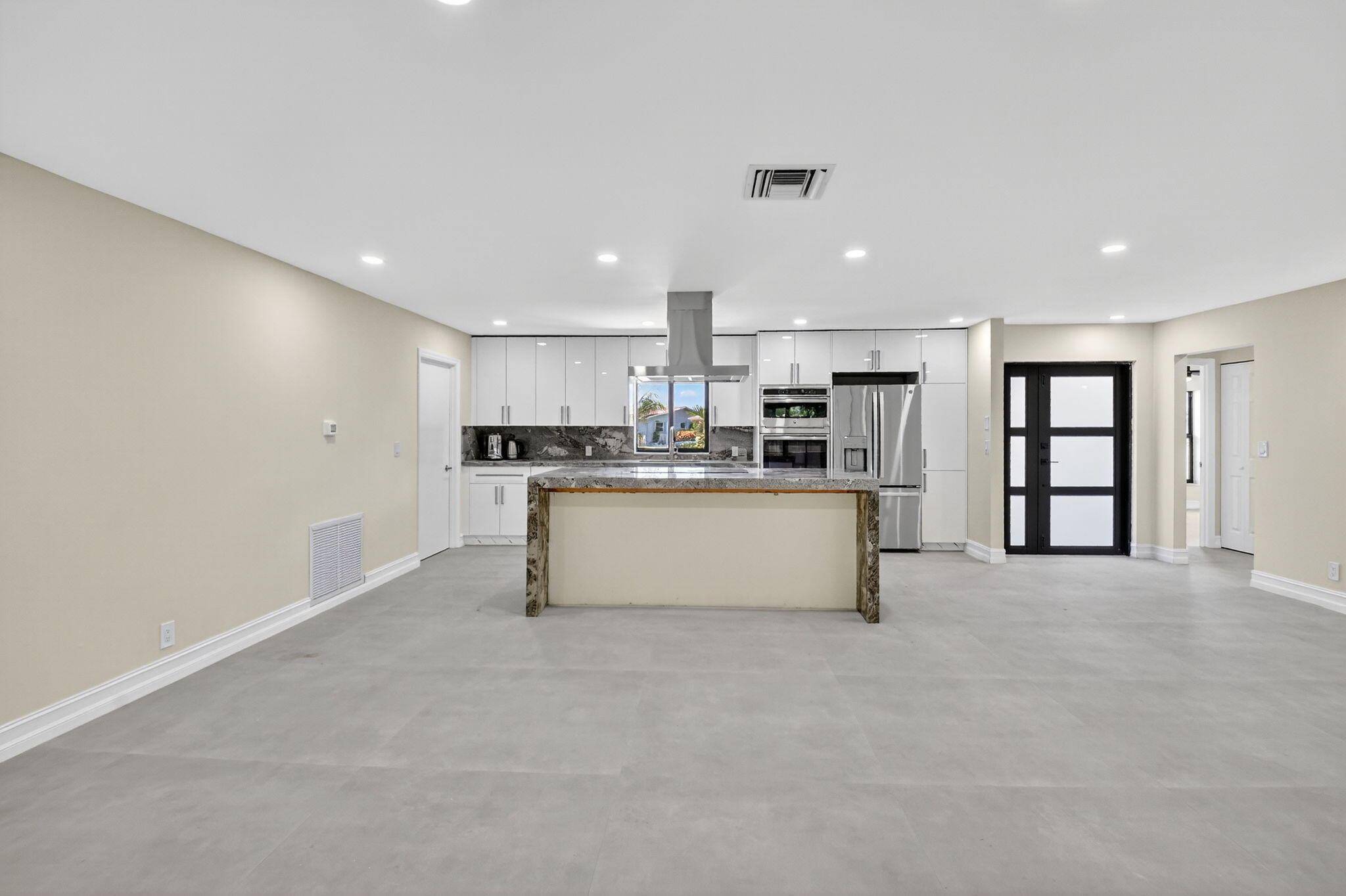 6251 Hitchin Post Way Delray Beach, FL 33484 - Photo 17 of 67 a large white kitchen with kitchen island a sink a center island stainless steel appliances and a cabinets