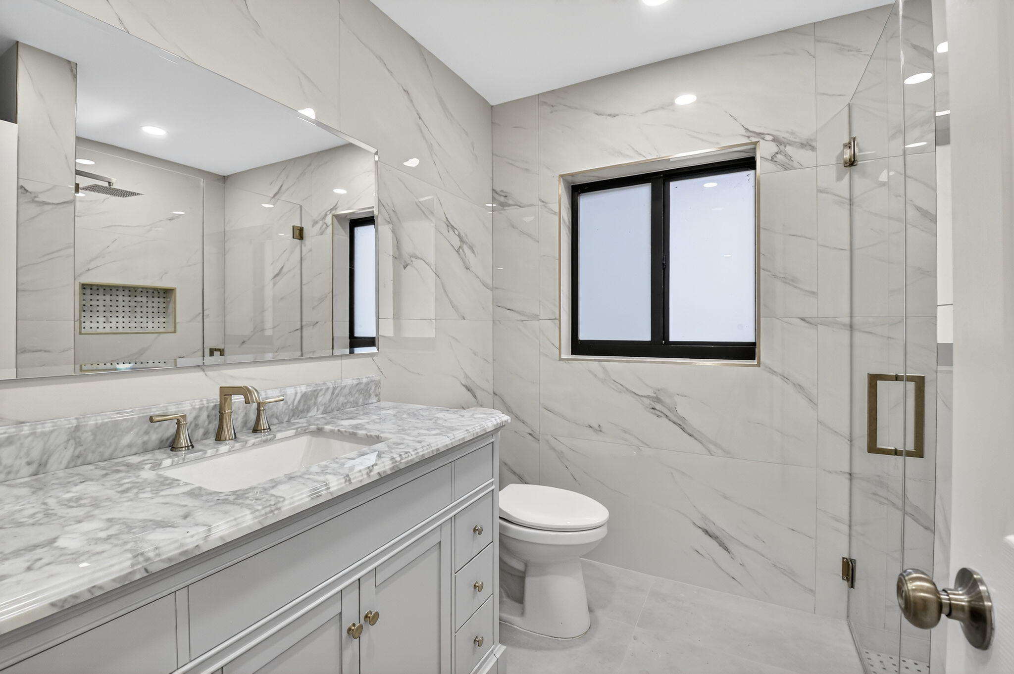 6251 Hitchin Post Way Delray Beach, FL 33484 - Photo 36 of 67 a bathroom with a granite countertop sink a toilet and a mirror