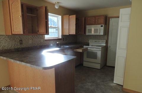 1900 Butte Road Blakeslee, PA 18610 - Photo 4 of 16 a kitchen with stainless steel appliances granite countertop a sink stove and cabinets