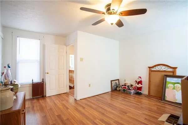 a view of a livingroom with hardwood floor and a ceiling fan