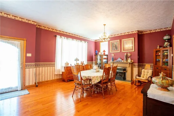 a dining room with furniture window and wooden floor