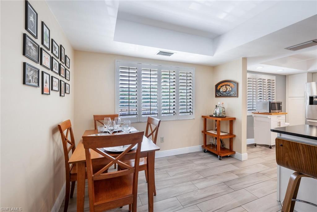 413 Augusta Boulevard, Unit 302 Naples, FL 34113 - Photo 11 of 39 a view of a dining room with furniture and window