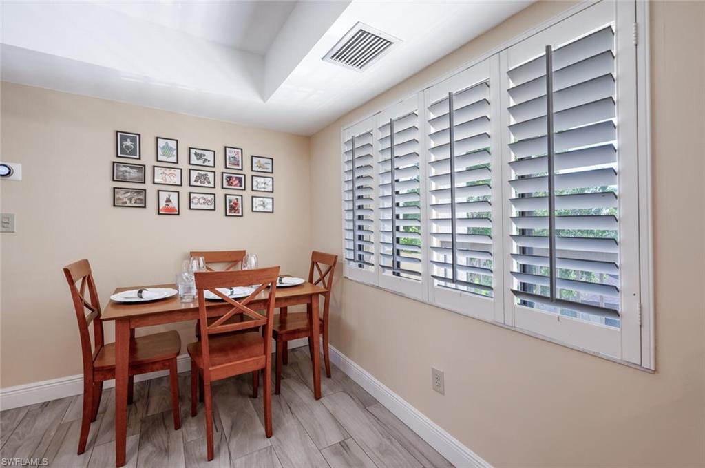 413 Augusta Boulevard, Unit 302 Naples, FL 34113 - Photo 12 of 39 a view of a dining room with furniture and window