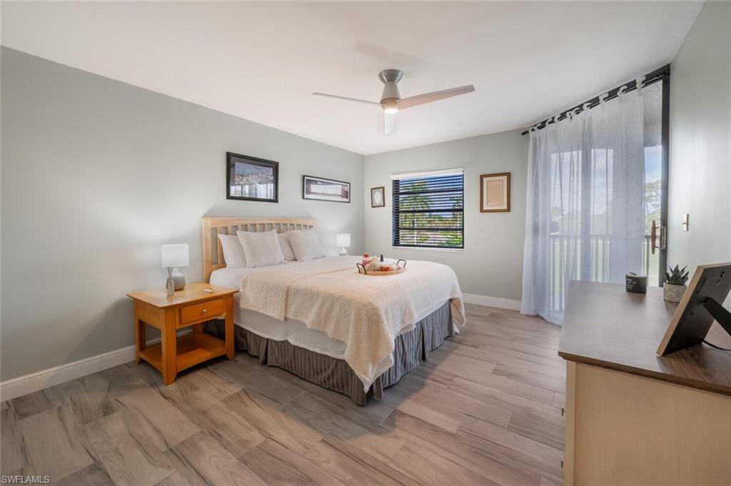413 Augusta Boulevard, Unit 302 Naples, FL 34113 - Photo 18 of 39 a bedroom with a bed and a chandelier