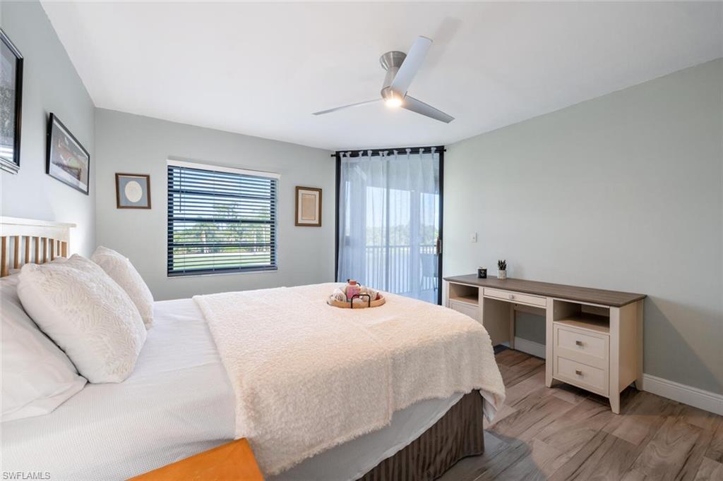 413 Augusta Boulevard, Unit 302 Naples, FL 34113 - Photo 20 of 39 a bedroom with a bed and a dresser