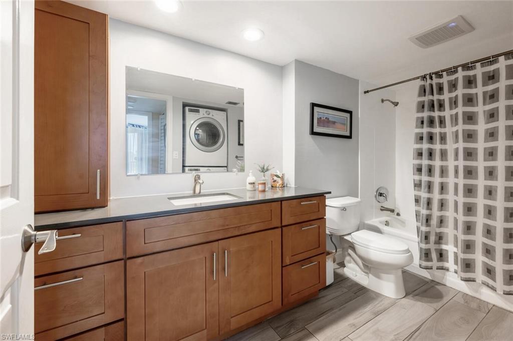 413 Augusta Boulevard, Unit 302 Naples, FL 34113 - Photo 22 of 39 a bathroom with a double vanity sink mirror and toilet