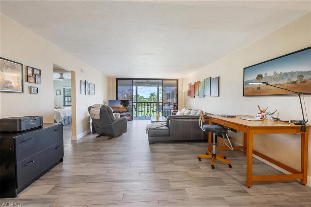 413 Augusta Boulevard, Unit 302 Naples, FL 34113 - Photo 3 of 39 a living room with furniture and a flat screen tv
