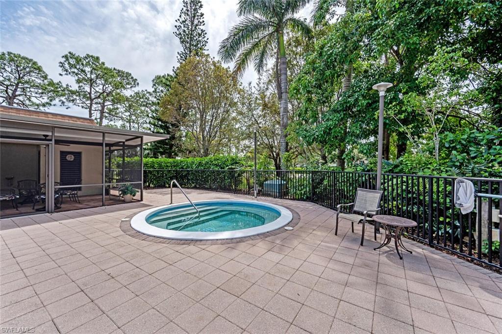 413 Augusta Boulevard, Unit 302 Naples, FL 34113 - Photo 36 of 39 a patio with a table and chairs and potted plants