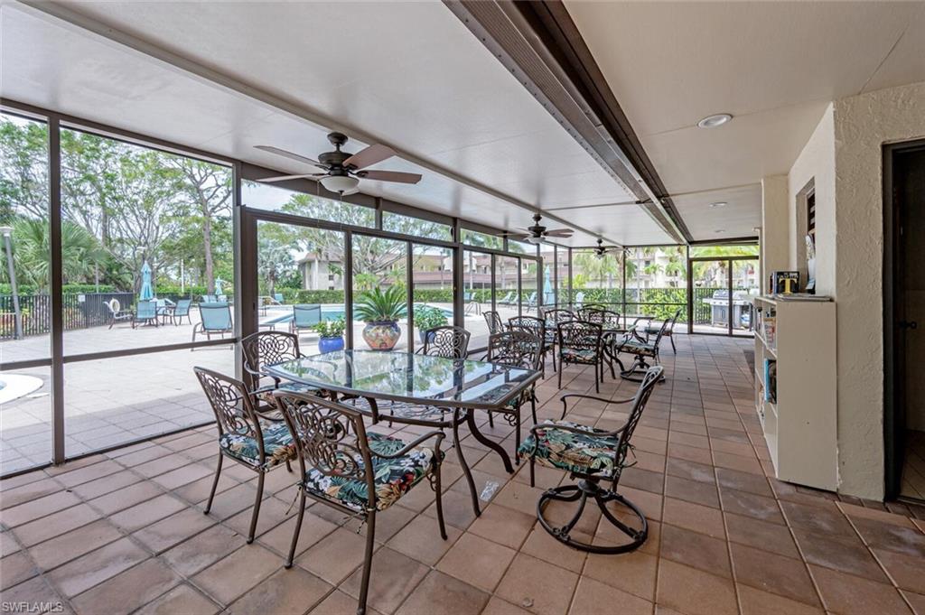 413 Augusta Boulevard, Unit 302 Naples, FL 34113 - Photo 37 of 39 a view of a dining room with furniture large windows and wooden floor