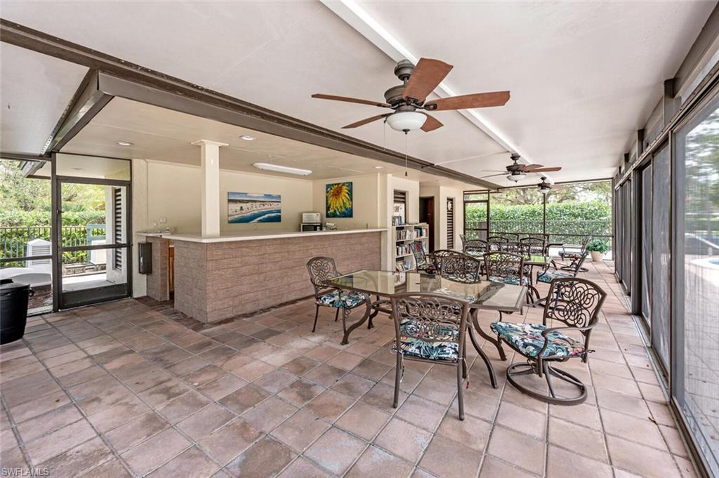 413 Augusta Boulevard, Unit 302 Naples, FL 34113 - Photo 38 of 39 a view of a dining room with furniture window and outside view