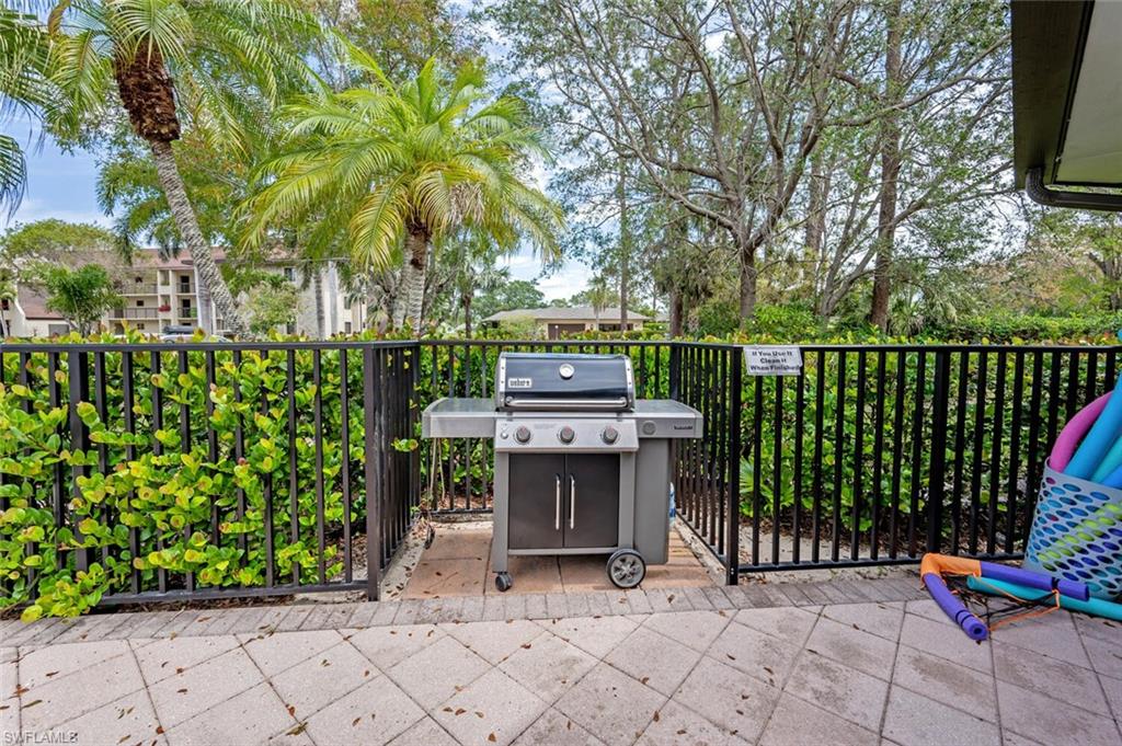 413 Augusta Boulevard, Unit 302 Naples, FL 34113 - Photo 39 of 39 a backyard of a house with fountain table and chairs